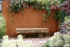 Sandstone bench with rusting steel wall